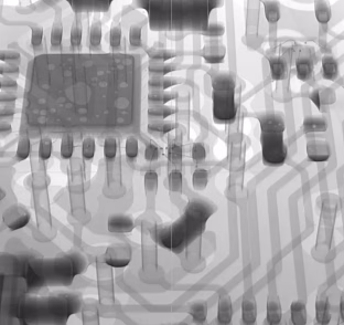 Close-up grayscale of a circuit board showing an integrated circuit chip and surrounding traces and components